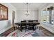 Formal dining room with a modern chandelier, large window, and sophisticated rug, perfect for hosting gatherings at 14 Long Island Pl., Atlanta, GA 30328
