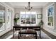 Elegant dining room with large windows, a modern chandelier, and a neutral color palette at 14 Long Island Pl., Atlanta, GA 30328