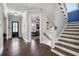 Welcoming foyer featuring hardwood floors, staircase, and stylish decor, creating a seamless flow into the home at 14 Long Island Pl., Atlanta, GA 30328