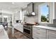 Modern kitchen with stainless steel appliances, gray backsplash, and ample counter space at 14 Long Island Pl., Atlanta, GA 30328