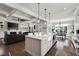 Spacious kitchen with a large island, white cabinets, and open concept layout to living and dining areas at 14 Long Island Pl., Atlanta, GA 30328