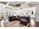 Spacious living room features a large sectional, coffered ceiling, and seamless flow to the kitchen at 14 Long Island Pl., Atlanta, GA 30328