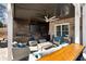 Inviting covered patio with lounge seating, TV, and bar is perfect for relaxation at 14 Long Island Pl., Atlanta, GA 30328