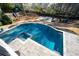 View of the pool area featuring a spa, stone patio, and ample room for entertaining at 14 Long Island Pl., Atlanta, GA 30328