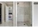 View of a tiled shower with glass doors, built in bench and access to closet/bedroom at 14 Long Island Pl., Atlanta, GA 30328