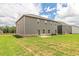 Expansive backyard view of a home with gray siding and a brick foundation at 1598 Sungrown Way, Mcdonough, GA 30253