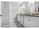 This bright bathroom features a double sink with granite countertops and white cabinets at 444 W Lake Nw Ave, Atlanta, GA 30318