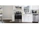 Well-lit kitchen with stainless steel appliances, white cabinetry, and granite countertops for a modern design at 444 W Lake Nw Ave, Atlanta, GA 30318
