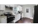 Modern kitchen equipped with stainless steel appliances, white cabinets, and granite countertops for a sleek look at 444 W Lake Nw Ave, Atlanta, GA 30318