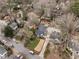 Aerial view of a home nestled among mature trees, showcasing its proximity to other residences and roadways at 2044 Cottage Nw Ln, Atlanta, GA 30318