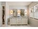 Well-lit bathroom with double sink vanity, marble countertops, gold fixtures, and built in wardrobe at 2044 Cottage Nw Ln, Atlanta, GA 30318