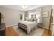 Sunlit bedroom featuring wood floors, ample windows, and stylish decor at 2044 Cottage Nw Ln, Atlanta, GA 30318