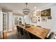 Spacious dining room featuring a long, rustic table, modern lighting, and stylish wall decor at 2044 Cottage Nw Ln, Atlanta, GA 30318