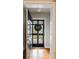 Bright entryway showcasing hardwood floors and a modern black front door with glass panes at 2044 Cottage Nw Ln, Atlanta, GA 30318