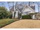 Charming home featuring a white exterior, covered porch, and professionally landscaped yard at 2044 Cottage Nw Ln, Atlanta, GA 30318