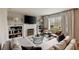 Inviting living room with a fireplace, built-in shelving, and a large window providing natural light at 2044 Cottage Nw Ln, Atlanta, GA 30318