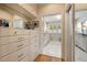 A lux walk-in closet features built in drawers, mirrors, and hardwood floors at 2044 Cottage Nw Ln, Atlanta, GA 30318