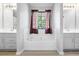 Bright bathroom featuring a central soaking tub between two vanities with a window above at 225 Stonewood Ct, Temple, GA 30179