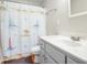 Bright bathroom features a white marble vanity, gray cabinets and a novelty shower curtain at 225 Stonewood Ct, Temple, GA 30179