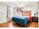 Cozy bedroom with hardwood floors features a ceiling fan, neutral walls, and warm natural lighting at 225 Stonewood Ct, Temple, GA 30179