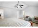 Bright bedroom with vaulted ceiling, ceiling fan, sitting area, and doorway to bathroom at 225 Stonewood Ct, Temple, GA 30179