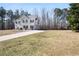 Beautiful two-story home featuring a large yard, attached two-car garage, and a long driveway at 225 Stonewood Ct, Temple, GA 30179