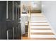 Welcoming foyer with hardwood floors, an open staircase, and a glimpse of the upper-level living area at 225 Stonewood Ct, Temple, GA 30179