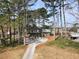 Aerial view of a home on a large lot with a long driveway and mature trees at 4397 Shady Drive Nw, Lilburn, GA 30047
