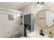Bathroom with a glass shower, white marble tile, black fixtures, and a gold mirror at 4397 Shady Drive Nw, Lilburn, GA 30047