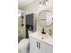 Bathroom featuring white vanity, gold mirror, and tiled shower with matte black hardware at 4397 Shady Drive Nw, Lilburn, GA 30047