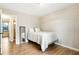 Bedroom featuring wood floors, a mirror, light-colored walls and furnishings, and natural light at 4397 Shady Drive Nw, Lilburn, GA 30047