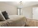 Bedroom with wood floors, modern lighting, a window, and a neutral color palette at 4397 Shady Drive Nw, Lilburn, GA 30047