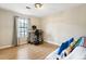 Bedroom featuring wood floors, light-colored walls and furnishings, and natural light from window at 4397 Shady Drive Nw, Lilburn, GA 30047