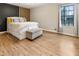 Calm bedroom with a large window, modern accents and wood-look flooring exudes comfort at 4397 Shady Drive Nw, Lilburn, GA 30047