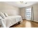 Bedroom featuring wood floors, light-colored walls and furnishings, and natural light from window at 4397 Shady Drive Nw, Lilburn, GA 30047