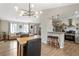 Open-concept kitchen with granite counters, stainless steel appliances, and seamless flow to dining and living areas at 4397 Shady Drive Nw, Lilburn, GA 30047