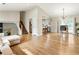 Spacious living room seamlessly connects to the kitchen and dining area, featuring wood floors and natural light at 4397 Shady Drive Nw, Lilburn, GA 30047