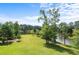 Expansive backyard featuring lush green grass, mature trees, and lake access at 2948 Legion Lake Rd, Douglasville, GA 30135