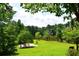 Breathtaking backyard showcasing lush greenery, serene lake views, and cozy outdoor seating at 2948 Legion Lake Rd, Douglasville, GA 30135