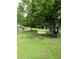 Backyard with a classic wooden swing hanging from a mature tree, perfect for outdoor relaxation at 2948 Legion Lake Rd, Douglasville, GA 30135