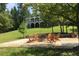 Charming backyard with a fire pit surrounded by Adirondack chairs, perfect for entertaining at 2948 Legion Lake Rd, Douglasville, GA 30135