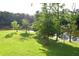 Scenic backyard with lush greenery and a tranquil lake view, perfect for outdoor enjoyment at 2948 Legion Lake Rd, Douglasville, GA 30135