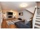 Cozy basement featuring a fireplace, comfortable seating, and a staircase leading to the upper level at 2948 Legion Lake Rd, Douglasville, GA 30135