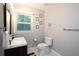 Clean bathroom featuring modern fixtures, a toilet, and a sink with a dark wood vanity at 2948 Legion Lake Rd, Douglasville, GA 30135