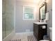 Modern bathroom featuring a glass-enclosed shower, vanity with sink, and tile flooring at 2948 Legion Lake Rd, Douglasville, GA 30135