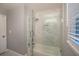 Bright bathroom with a shower featuring glass doors, marble tile, and modern fixtures at 2948 Legion Lake Rd, Douglasville, GA 30135