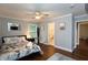 Bright bedroom featuring a stylish bed, wood floors, and an ensuite bathroom at 2948 Legion Lake Rd, Douglasville, GA 30135