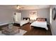 Spacious bedroom featuring hardwood floors, ceiling fan, two beds, and modern decor, bathed in natural light at 2948 Legion Lake Rd, Douglasville, GA 30135