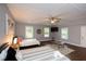 Bright bedroom with two beds, wood-look floors, ceiling fan, and natural light from the windows at 2948 Legion Lake Rd, Douglasville, GA 30135
