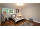 Bedroom featuring a comfortable bed, wooden floors, bright window and stylish decor at 2948 Legion Lake Rd, Douglasville, GA 30135